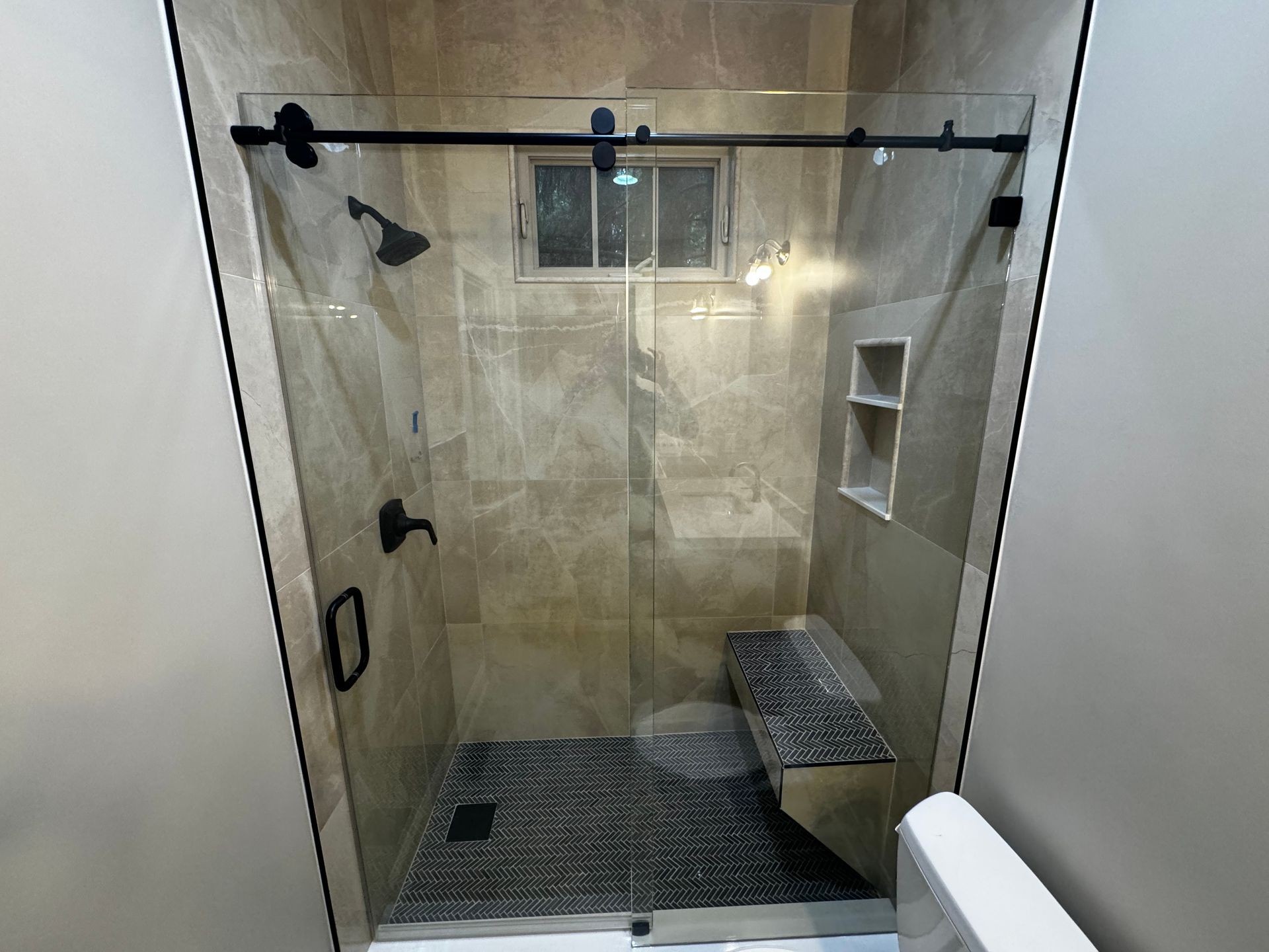 Bathroom remodel with tile shower and glass siding door 